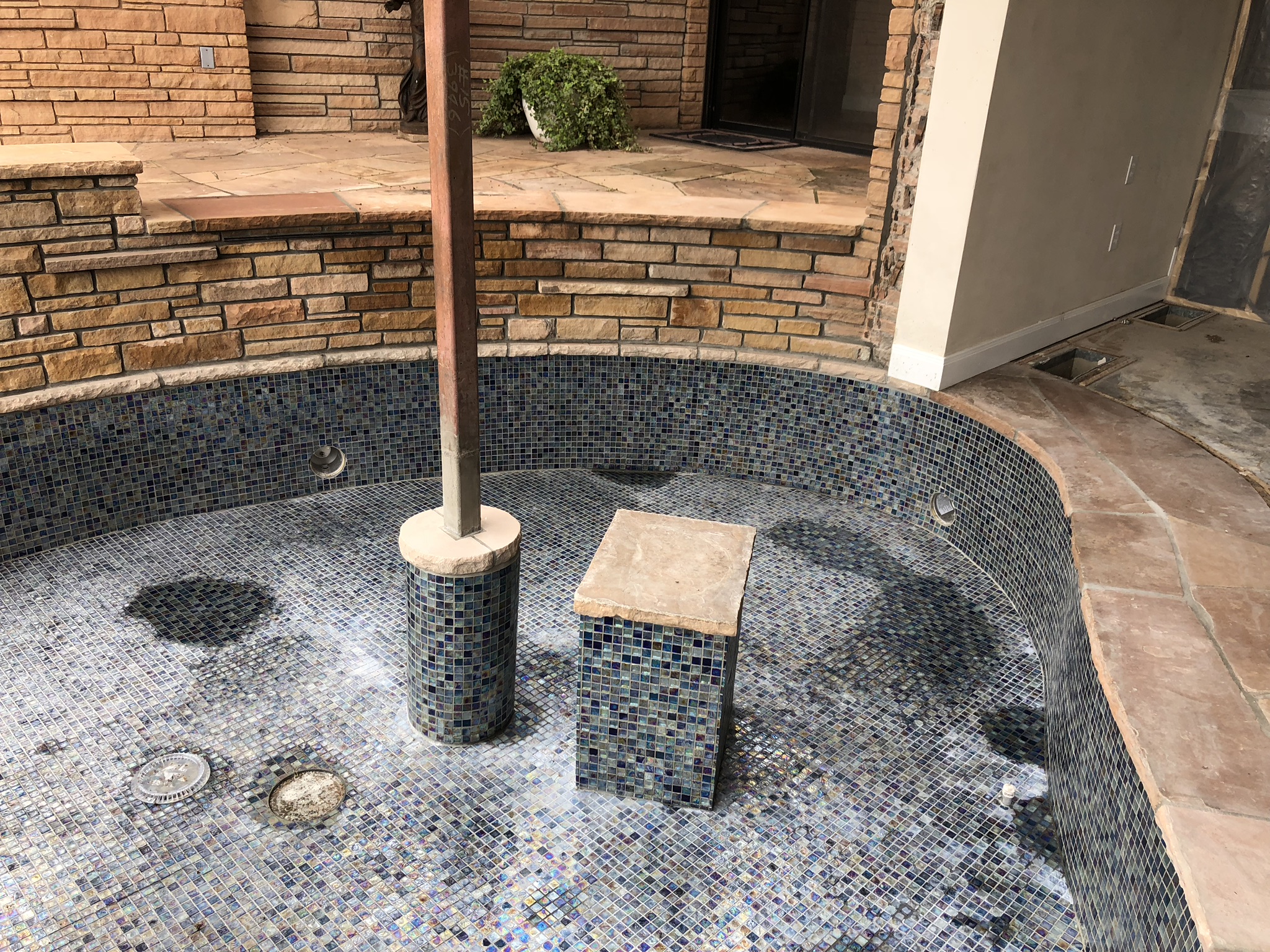 Our newly installed 1" Mosaic Glass Tile (once cleaned up) will create a gorgeous night setting. Combined with some illuminated LED nicheless pool lights, these water features will be able to take on any color you desire! Controlled by the palm of your hand, this will surely be a sight to see!