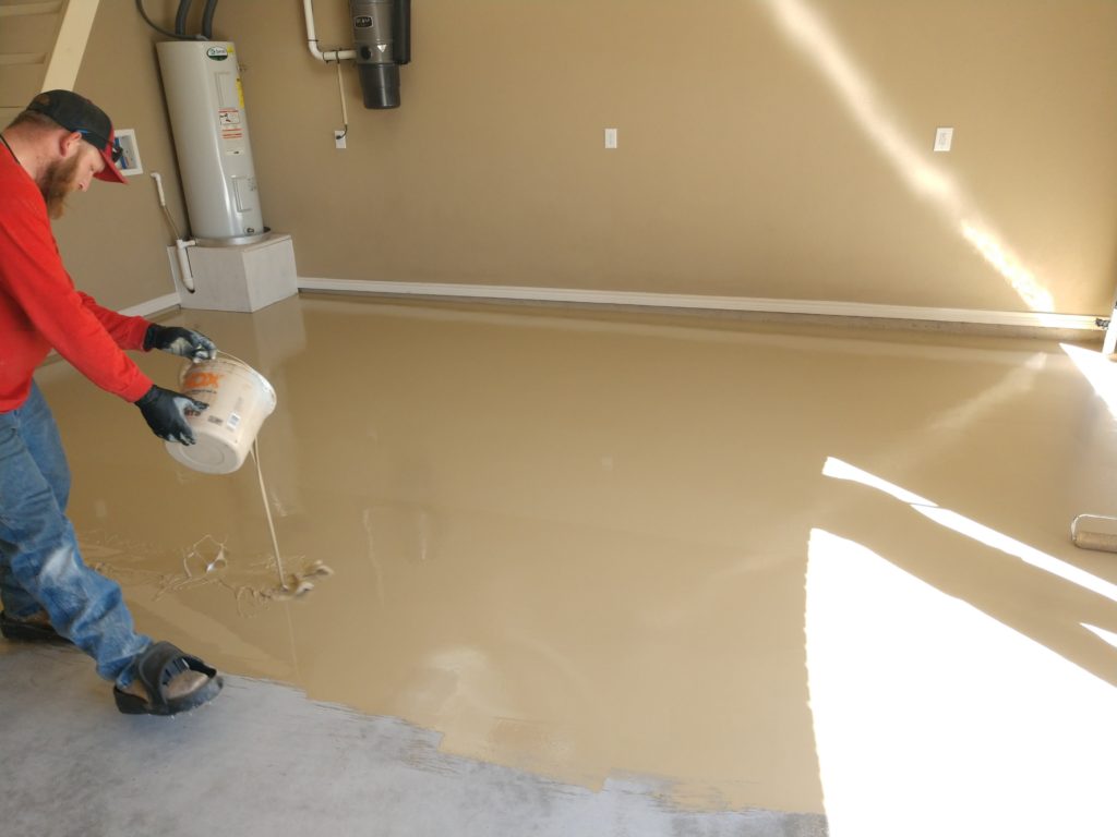 Lastly, we apply our Polyurea Primer / Basecoat. We also use a roller brush to help distribute this material evenly across your floors. Once the surface is smooth and even, we apply the Vinyl Chip flakes to complete our 1 Day Coating installation. 