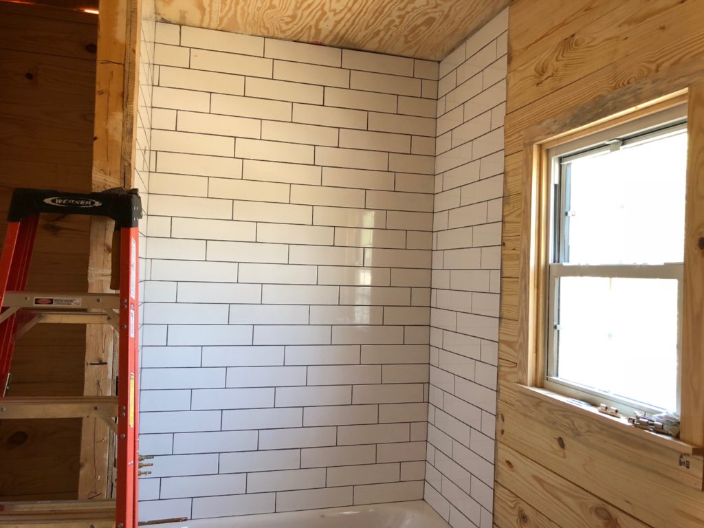 Part of our job involves building a beautiful bath tub & shower with classic white subway tiles. Here you can see we've installed the tile and are allowing the thin-set to dry & bond the tile to the wall. 