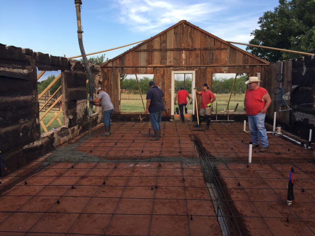 Part of our renovation process involves fixing the foundation and creating a whole new concrete slab for the base of the home Our crews are seen here framing our groundwork and pouring our concrete material. This is arduous work but paramount to the future health of the home.