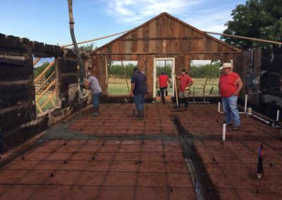 Part of our renovation process involves fixing the foundation and creating a whole new concrete slab for the base of the home Our crews are seen here framing our groundwork and pouring our concrete material. This is arduous work but paramount to the future health of the home.