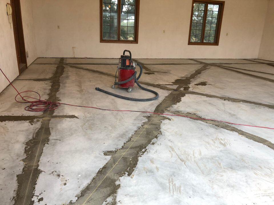 This image is a great example of the care in the pre-installation process that we follow. Our crews work diligently and carefully to power wash, clean and vacuum your surface. Secondly, we look for any cracks and fill these cracks before applying our basecoat.