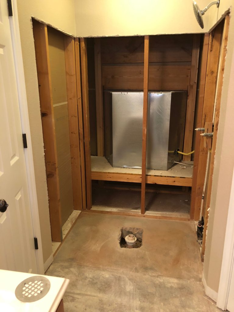 This is a beautiful picture of our demolition work. Here you can see the old shower has been ripped out down to the studs and concrete slab. We've removed any insulation and exposed all interior pipes and hardware. This gives our crews an excellent tapestry to build our new shower inside of this clean workspace. The key here is cleanliness!